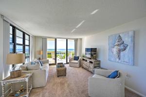 a living room with a couch and chairs and a television at Resort Condo with Balcony and Stunning Ocean Views! in Marco Island