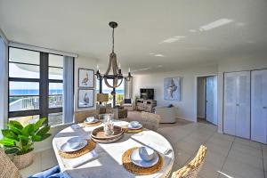 a dining room with a table and chairs with a view of the ocean at Resort Condo with Balcony and Stunning Ocean Views! in Marco Island