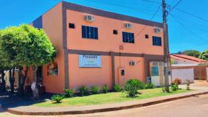 a large orange building on the side of a street at Hospedagem De Ferias in Bonito