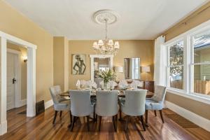 a dining room with a table and chairs and a chandelier at Dreamy Abode in Spokane