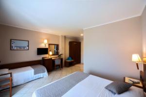 Postel nebo postele na pokoji v ubytování Hotel Le Palme