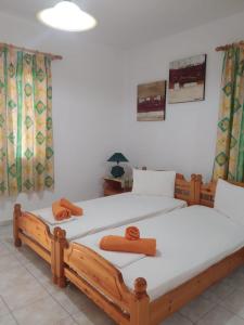 two twin beds in a room with at Mabella Beach in Plati