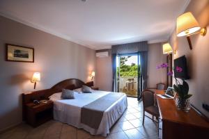 Postel nebo postele na pokoji v ubytování Hotel Le Palme