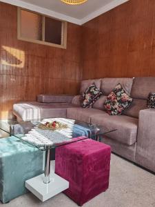 a living room with a couch and a table at Vivienda Vacacional El Majo in Siero