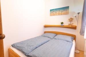 a bedroom with a bed with a blue comforter at Apartmány D u sjezdovky - Horní Mísečky in Horni Misecky