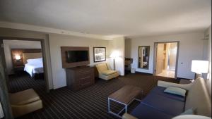 a hotel room with a bed and a living room at Holiday Inn Hazlet, an IHG Hotel in Hazlet