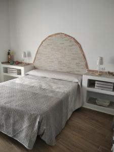 a bedroom with a large bed and two night stands at Casa Rural Los Nietos in Villaverde de Guadalimar