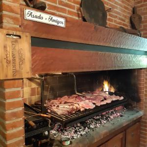 a rack of meat cooking in a brick oven at Casa Garay 602 in Mar del Plata