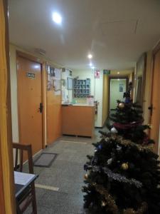 a room filled with furniture and a christmas tree at Hostal Cumbre in Zaragoza