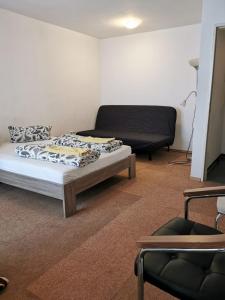 a living room with a bed and a couch at Apartment in the center in Dortmund