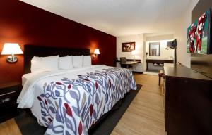 a hotel room with a bed and a desk at Red Roof Inn Detroit - Troy in Troy +22 photos
