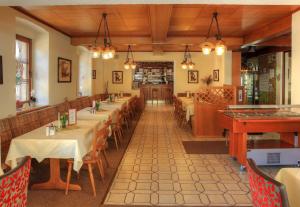 a dining room with tables and chairs in a restaurant at Hotel Moselterrasse in Ediger-Eller +67 photos