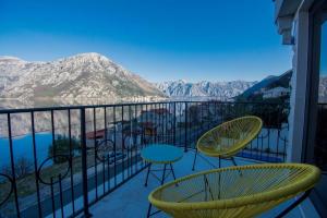 a balcony with chairs and a view of the mountains at Villa Viborg Boka Bay in Kotor