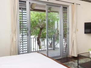 a view through a glass door of a room at Almond Tree Hotel Resort in Corozal