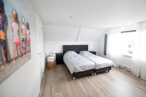 Postel nebo postele na pokoji v ubytování Strandvilla Roots