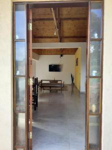 une porte ouverte dans une pièce avec une table dans l'établissement Chalés Alto da Serra 1, à Campos do Jordão