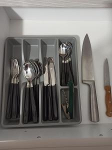 a tray filled with utensils in a drawer at Smart Chic Brasov in Braşov