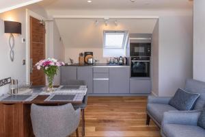 a kitchen and living room with a table and chairs at Inch Beach House B&B in Inch