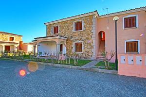 a large stone house with a driveway at Residence Stella Marina in San Teodoro