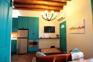 a kitchen with green cabinets and a refrigerator at Closson Studio - Stylish - Near Plaza - Queen bed in Santa Fe