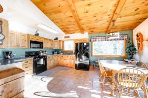 a kitchen with wooden cabinets and a table with chairs at High Lake Hideaway in Boulder Junction