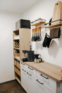 a kitchen with white cabinets and a wooden counter top at Ferienwohnung Bergoase in Fischen