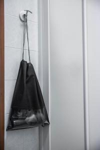 a black bag hanging on a wall next to a door at Bastimento in Fiorenzuola dʼArda