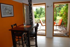 a dining room with a table and chairs and a patio at Ferienwohnung Hameln Jasmin in Hameln