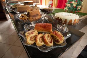 a buffet of different types of pastries on a table at Hotel Porto dos Milagres in Aparecida