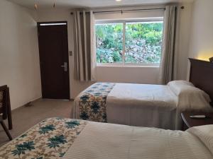 Voodi või voodid majutusasutuse Hotel Puerta Chichen toas