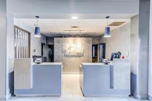 an office lobby with white and blue reception desks at Holiday Inn Express Hotel & Suites Ohio State University- OSU Medical Center, an IHG Hotel in Columbus