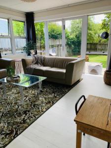 a living room with a couch and a table at Cooper's Cottage in Nelson