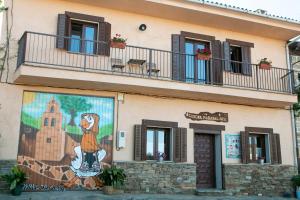 a building with a mural on the side of it at Casona de Rabanal-Oca in Rabanal del Camino