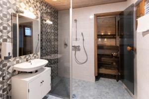 a bathroom with a shower, sink, and toilet at Holiday Village Nuorgamin Lomakeskus in Nuorgam