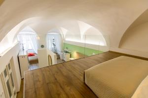 a bedroom with a bed in a room with an attic at Palác Daun - Studio Apartments in Znojmo