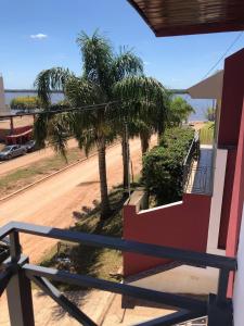 a balcony of a house with palm trees and a street at MAU-MAR in Colón