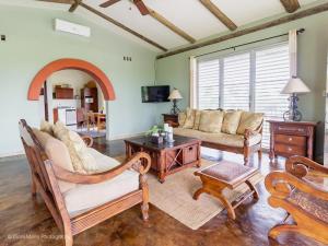 a living room filled with furniture and a fireplace at Almond Tree Hotel Resort in Corozal