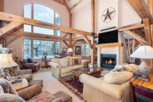 a living room filled with furniture and a fireplace at Double Eagle Way 102 in Telluride