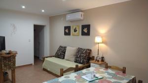 a living room with a couch and a table at Punto Sur Departamentos in Tandil
