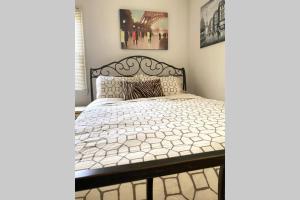 a bedroom with a bed with a black and white comforter at Beautiful house in the heart of Fair Oaks in Fair Oaks