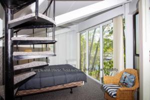 a bedroom with a bunk bed and a window at Unit 5 - Treetop 2 Bedroom Villa in Four Seasons