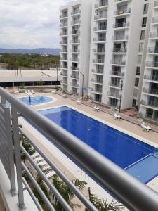 a view of a swimming pool from the balcony of a building at Apartamento Girardot in Girardot