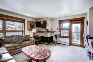 a living room with a couch and a table at Ski In, Ski Out 1 Bedroom Vacation Rental In The Heart Of Lionshead Village With Heated Slope Side Pool And Hot Tub in Vail