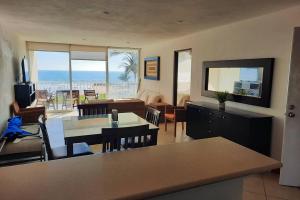 a living room with a view of the ocean at Departamento 105 , paraiso del pacifico in Coyuca