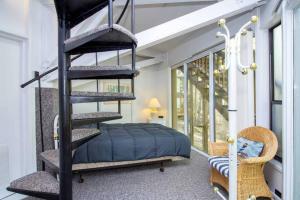 Cette chambre comprend un lit et un escalier en colimaçon noir. dans l'établissement Unit 8 - Treetop 2 Bedroom Villa, à Four Seasons