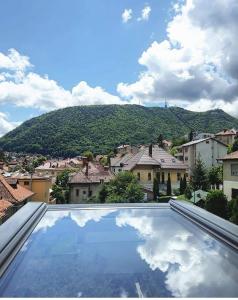 a large swimming pool with a view of a city at Casa Bologna in Braşov