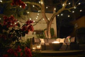 a living room with a couch and a tree with lights at Casa María Elena in San Miguel de Allende