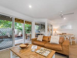 a living room with a couch and a table at Eastpoint 4 in Byron Bay