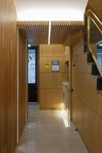 a hallway with wooden walls and a hallway with a door at Busan Lounge 26 Hotel in Busan