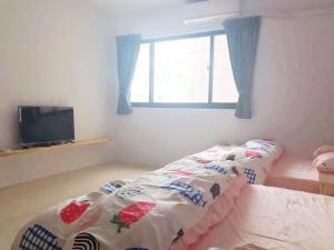 Postel nebo postele na pokoji v ubytování Zhong Xing Lohas Homestay